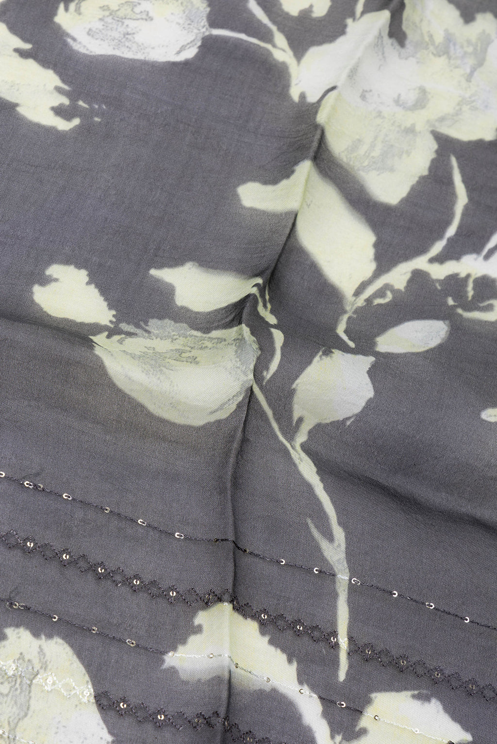 Close up of Black Organza Silk Saree with Embroidery on the body and Embroidery Border.  displaying folds