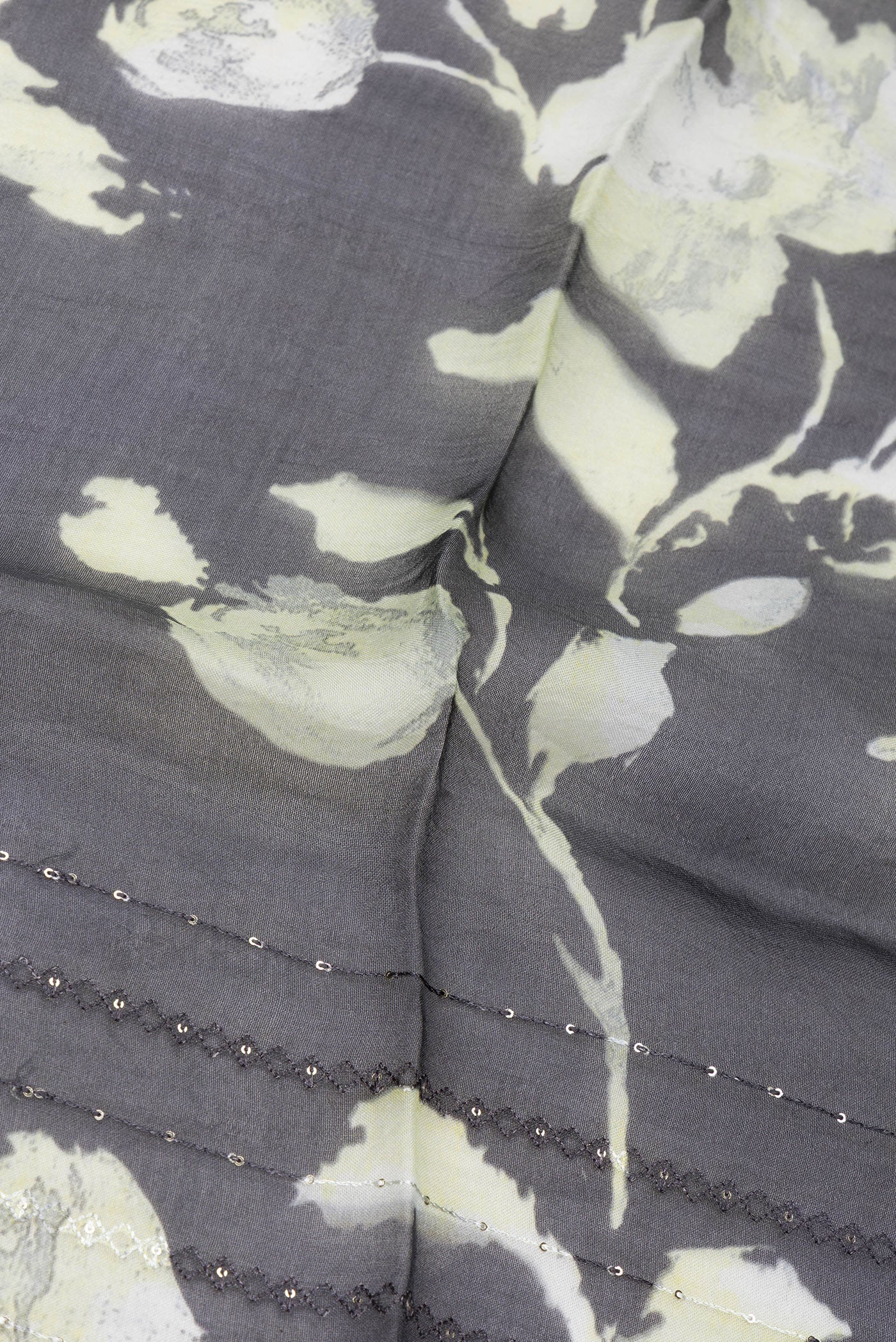 Close up of Black Organza Silk Saree with Embroidery on the body and Embroidery Border.  displaying folds