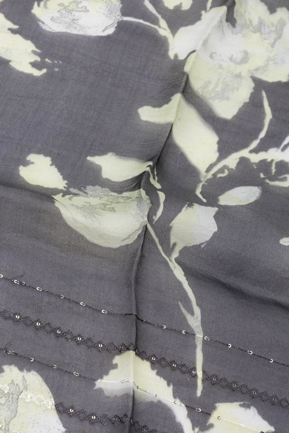 Close up of Black Organza Silk Saree with Embroidery on the body and Embroidery Border.  displaying folds