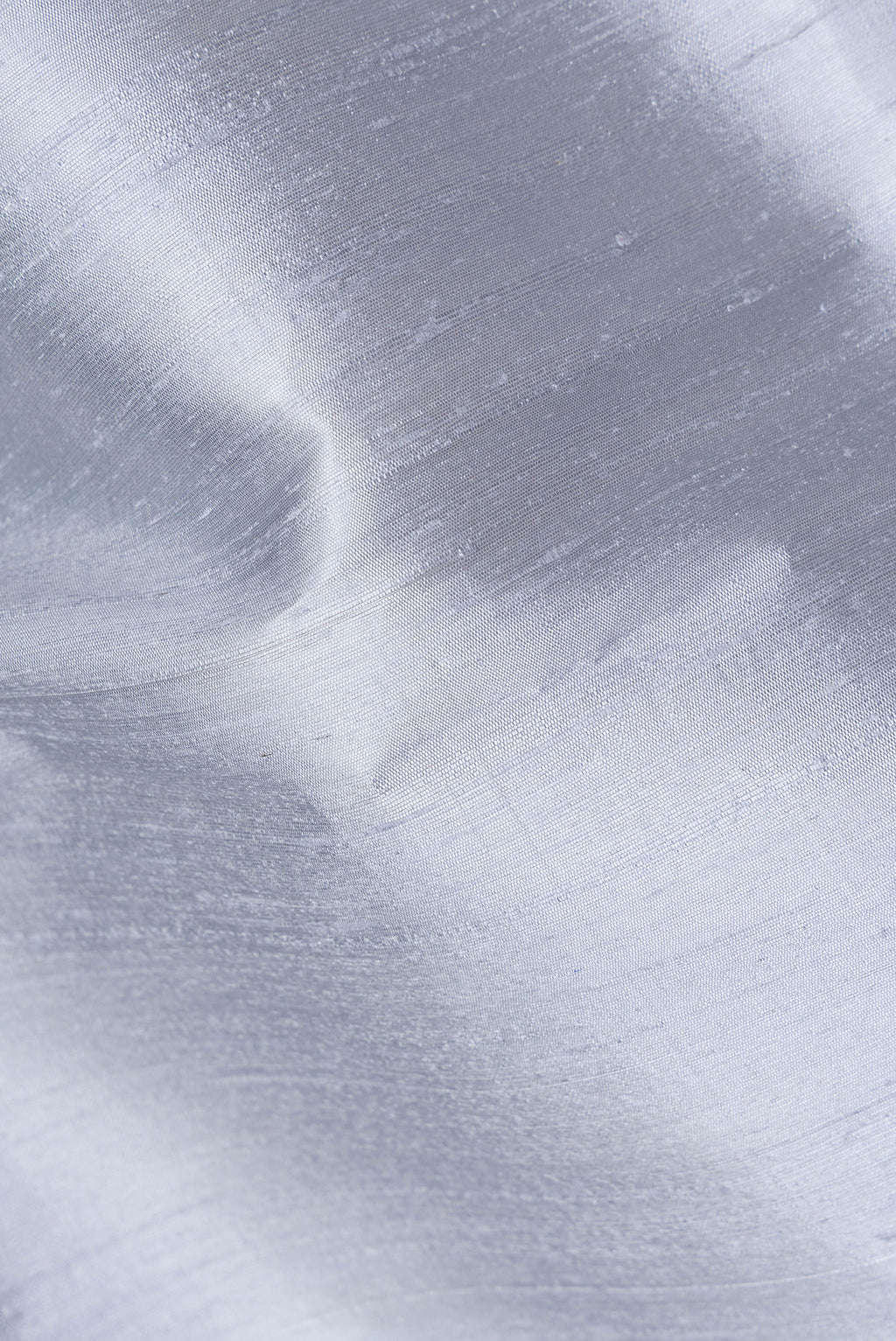 Close up of Grey Raw Saree with Plain Body and Zari Border.  displaying folds