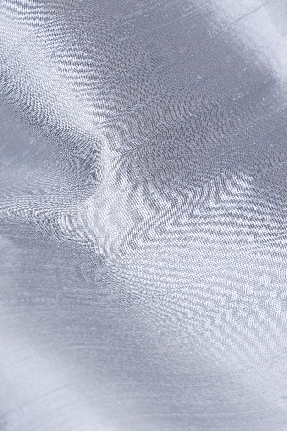 Close up of Grey Raw Saree with Plain Body and Zari Border.  displaying folds