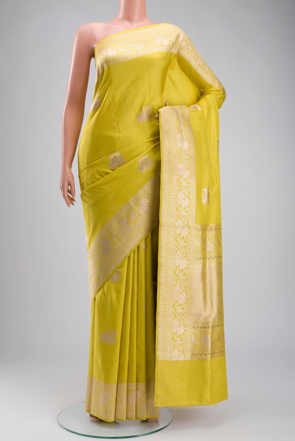 Yellow Banarasi Silk Saree with Zari Butta on the body and Zari Border displayed on a mannequin