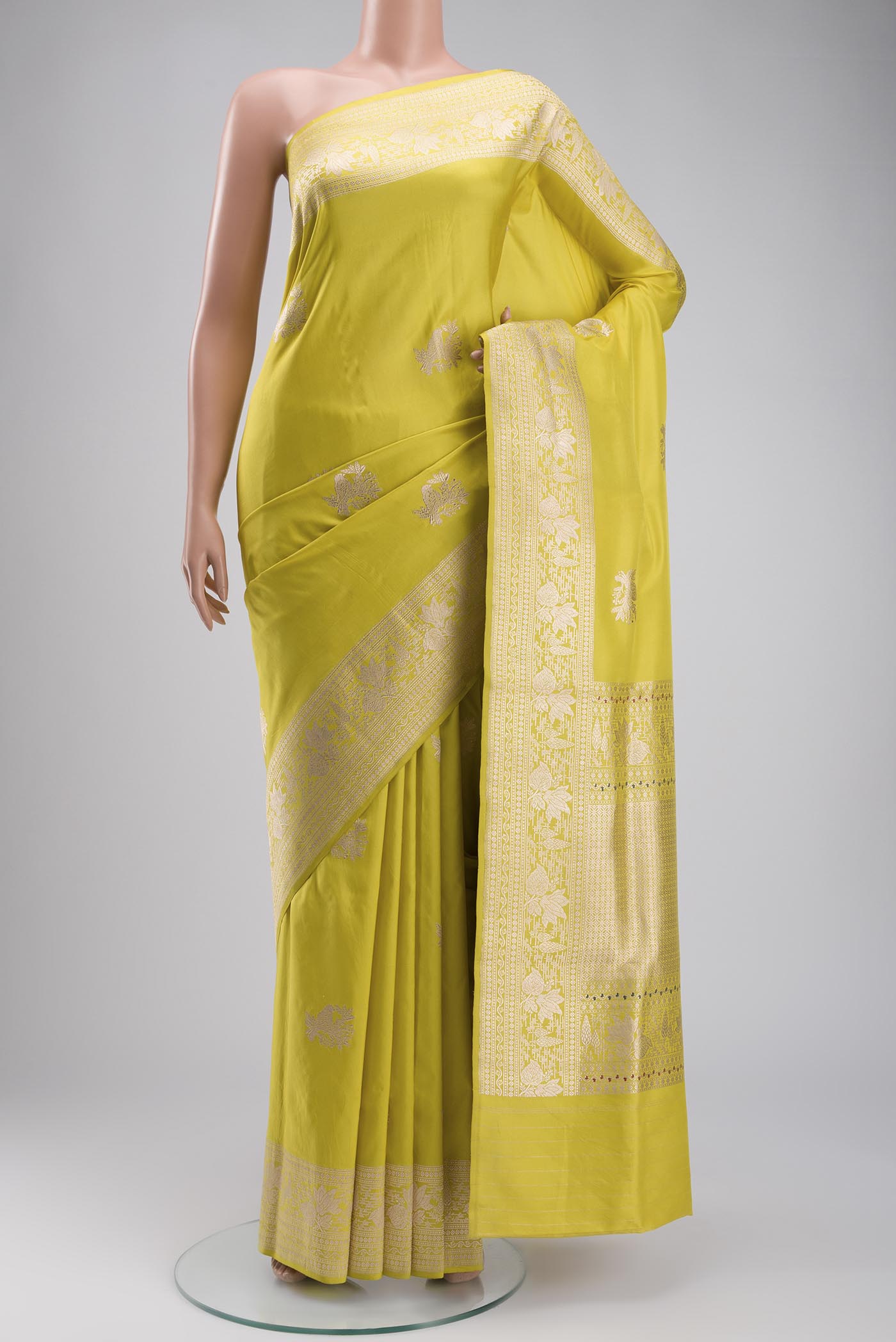 Yellow Banarasi Silk Saree with Zari Butta on the body and Zari Border displayed on a mannequin
