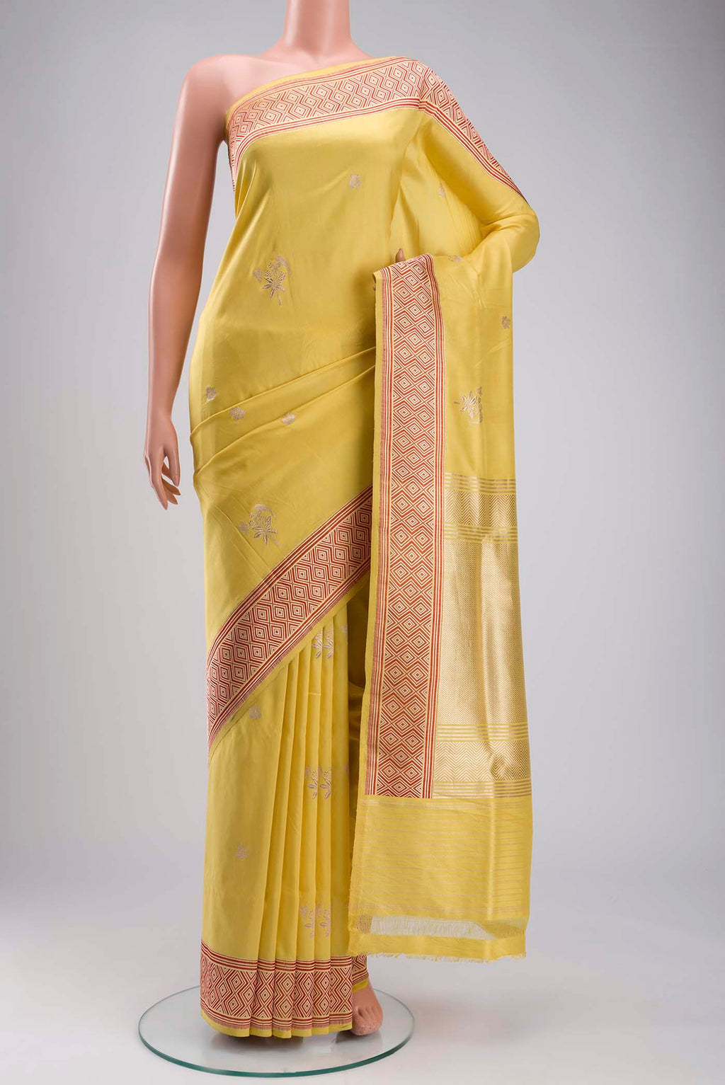 Yellow Banarasi Silk Saree with Zari Butta on the body and Zari Border displayed on a mannequin