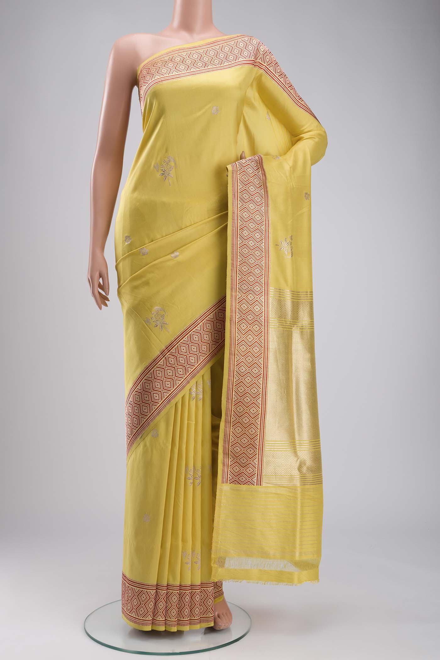 Yellow Banarasi Silk Saree with Zari Butta on the body and Zari Border displayed on a mannequin