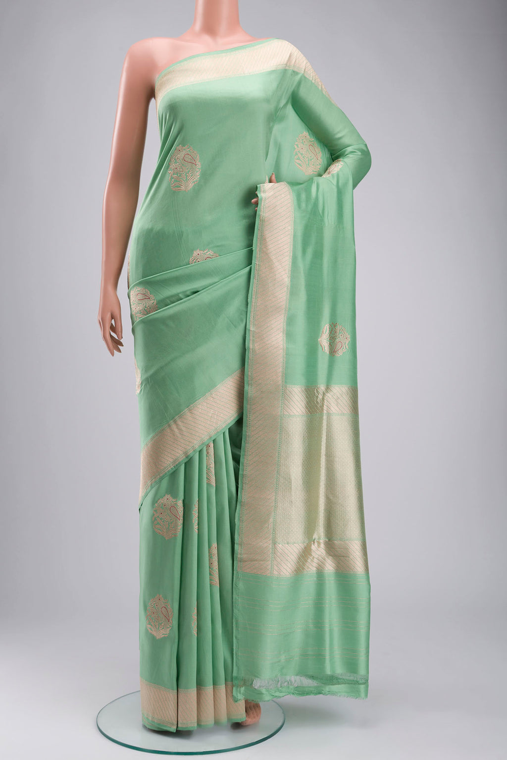 Green Banarasi Silk Saree with Zari Butta on the body and Zari Border displayed on a mannequin