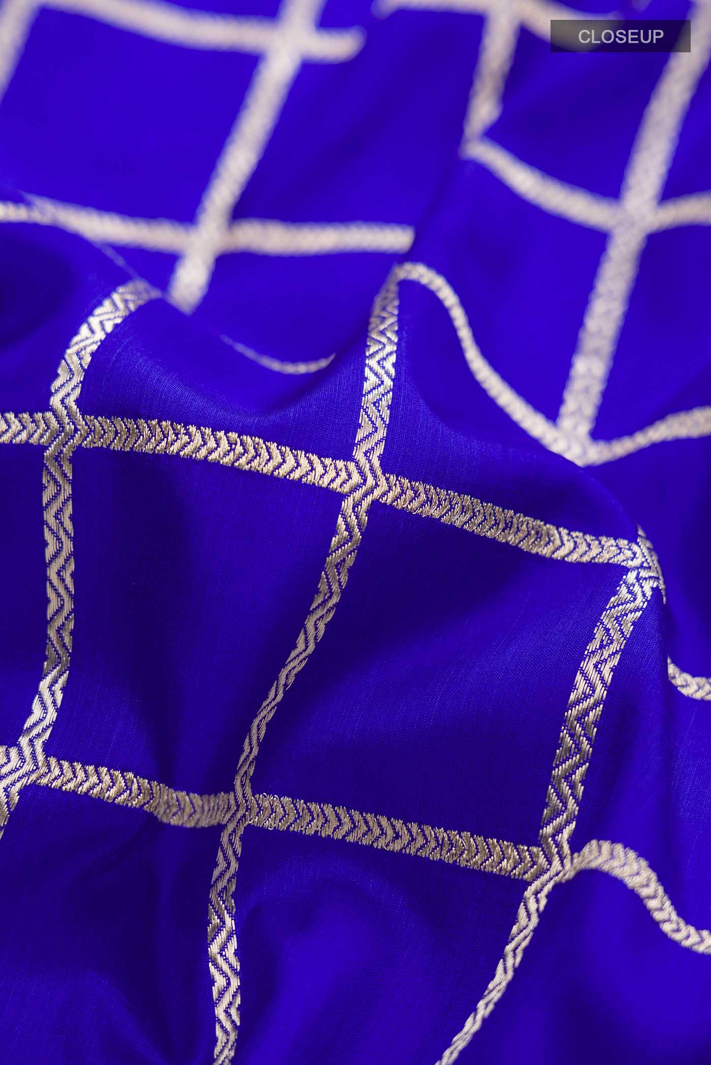 Close up of Royal Blue Banarasi Silk Saree with Checked design on the body and Zari Border displaying folds