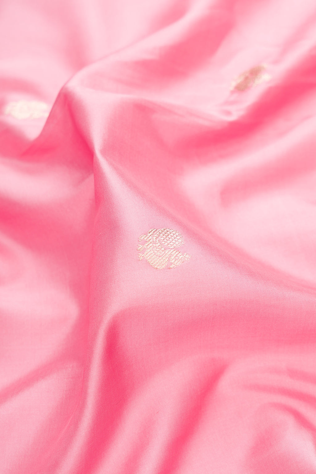 Close up of Pure Silk Rose pink Banarasi Saree with Zari Butta on the body and Fancy Border.  displaying folds