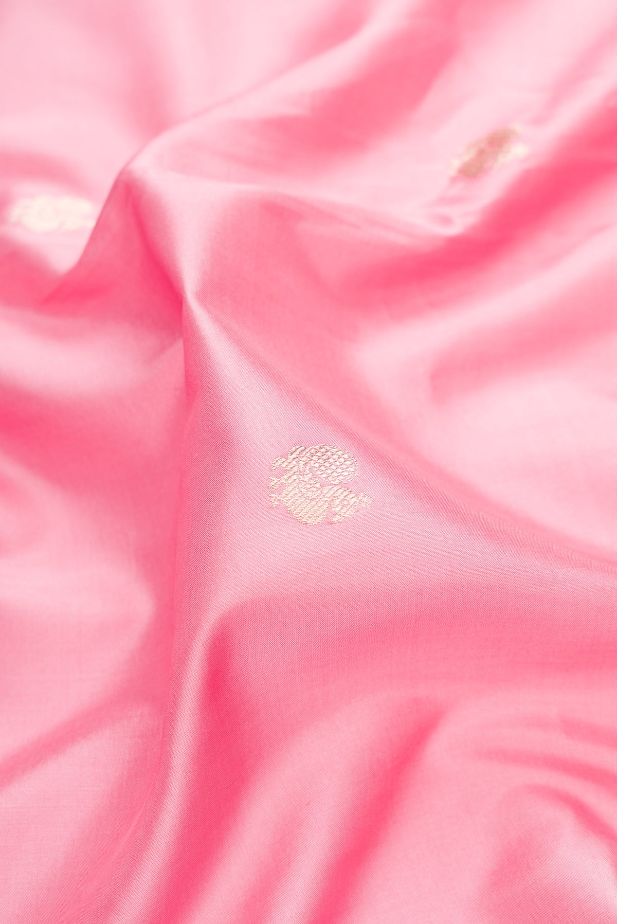 Close up of Pure Silk Rose pink Banarasi Saree with Zari Butta on the body and Fancy Border.  displaying folds