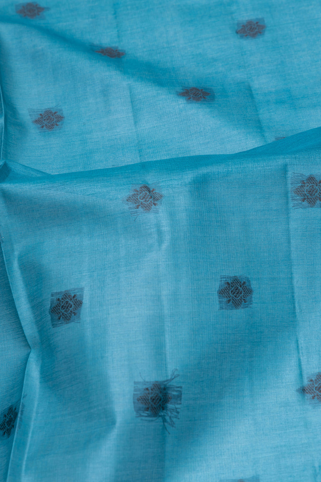 Close up of Peacock Blue Banarasi Tussar Silk Saree with Thread Butta on the body and Temple Border.  displaying folds