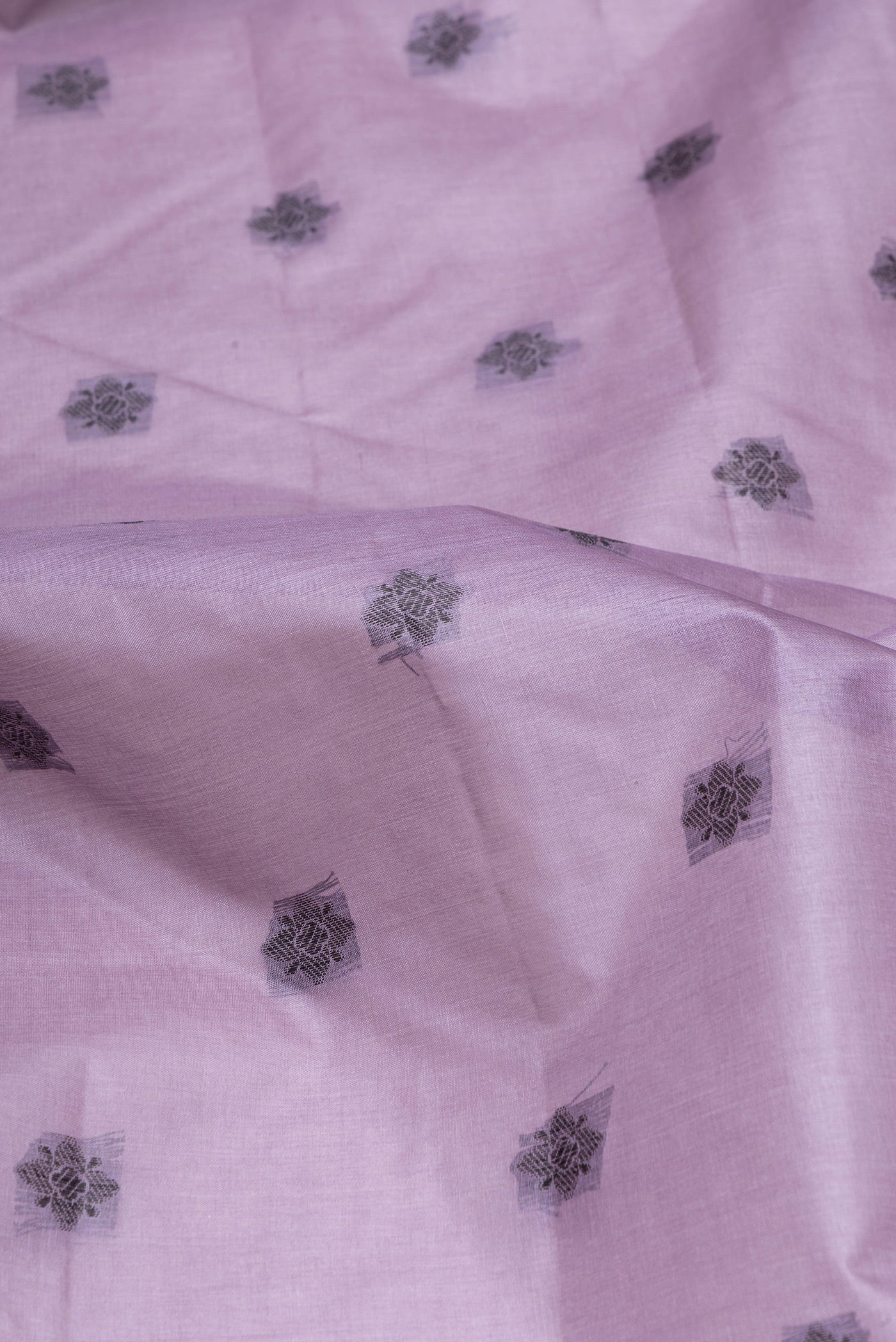 Close up of Lavender Banarasi Tussar Silk Saree with Thread Butta on the body and Fancy Border.  displaying folds