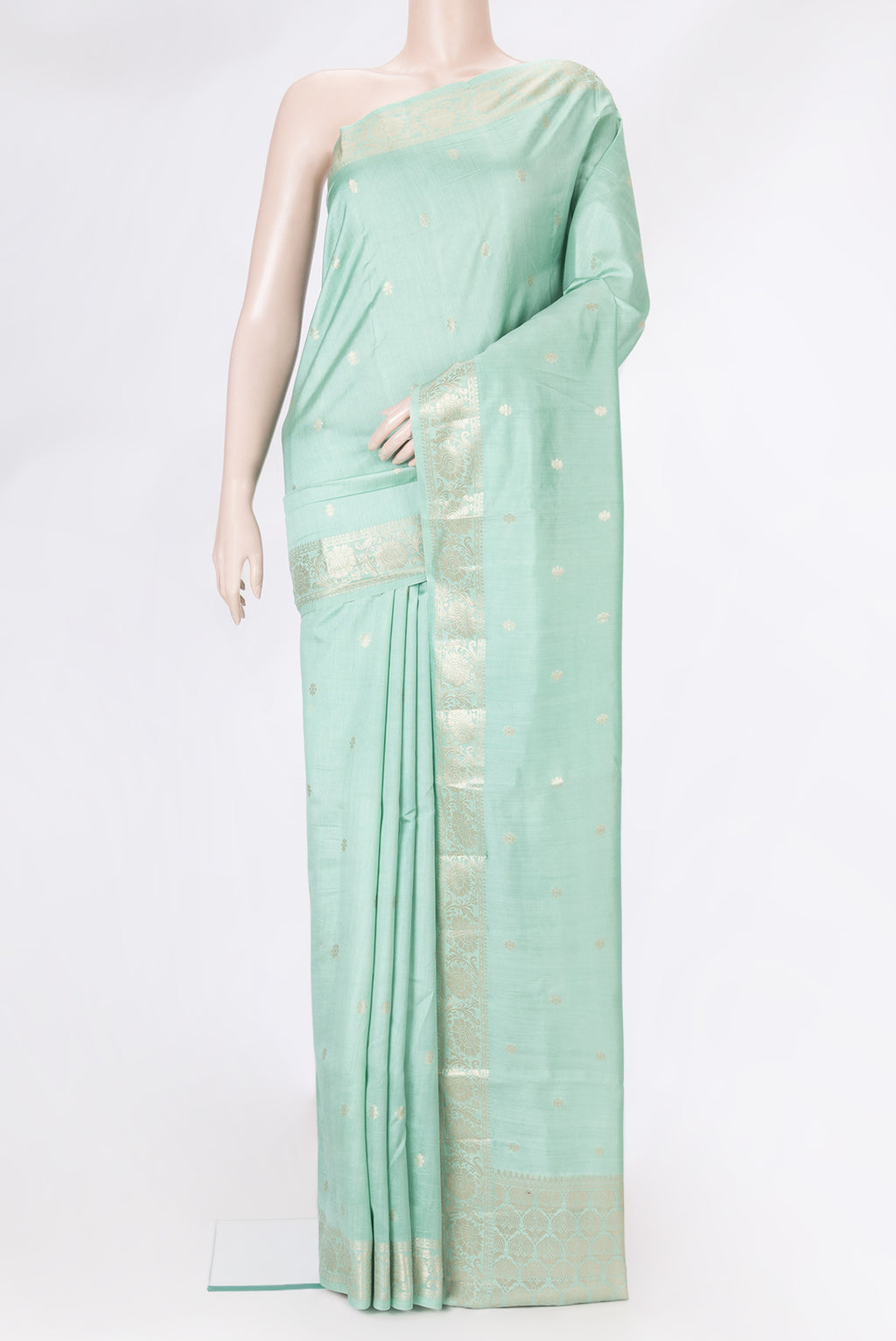 Sea Green Tussar Silk Saree with Zari Butta on the body and Zari Border.  displayed on a mannequin