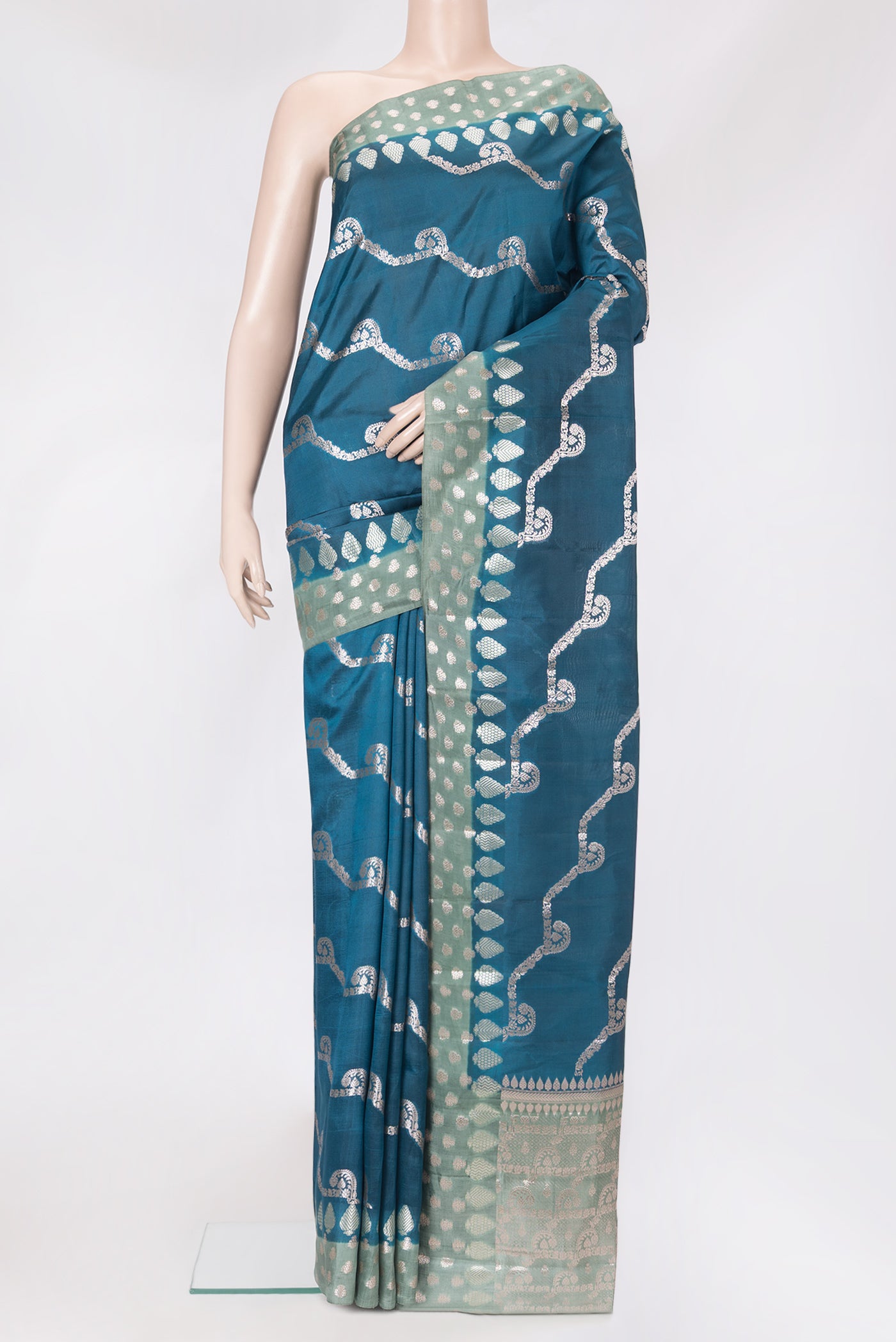 Peacock Blue Dual Tone Tussar Silk Saree with Zari Butta on the body and Fancy Border.  displayed on a mannequin