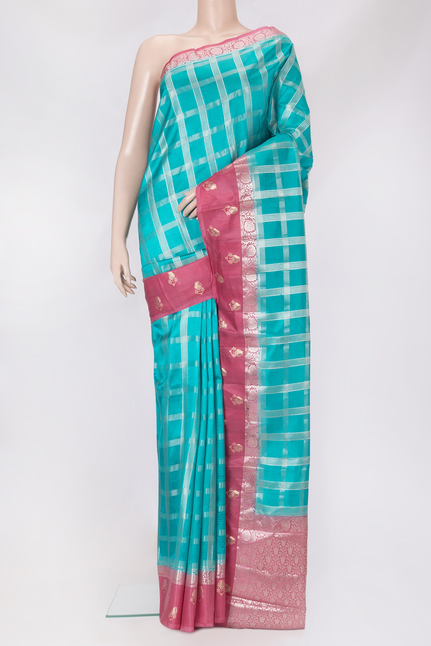 Sky Blue Dual Tone Tussar Silk Saree with Checked design on the body and Fancy Border.  displayed on a mannequin