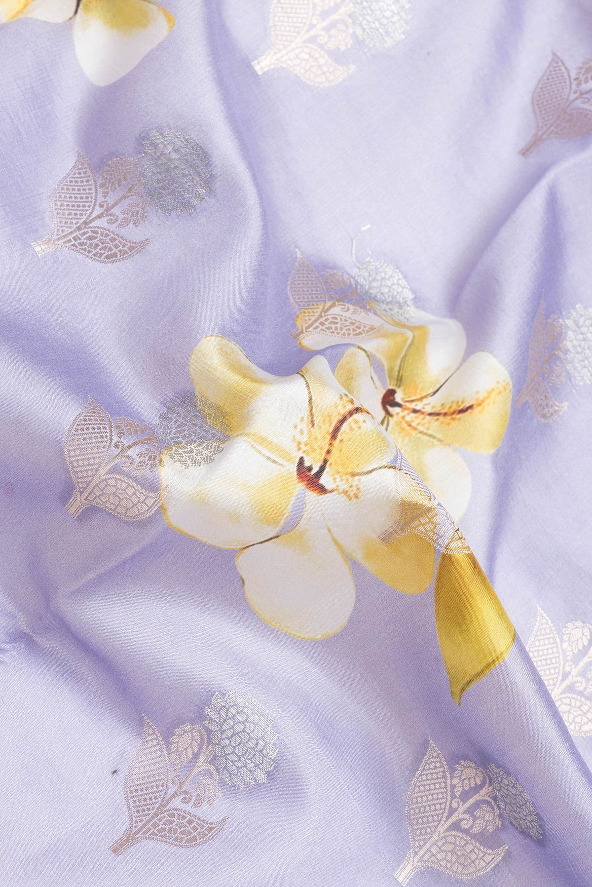 Close up of Lavender Dual Tone Tussar Silk Saree with Zari Butta on the body and Zari Border.  displaying folds