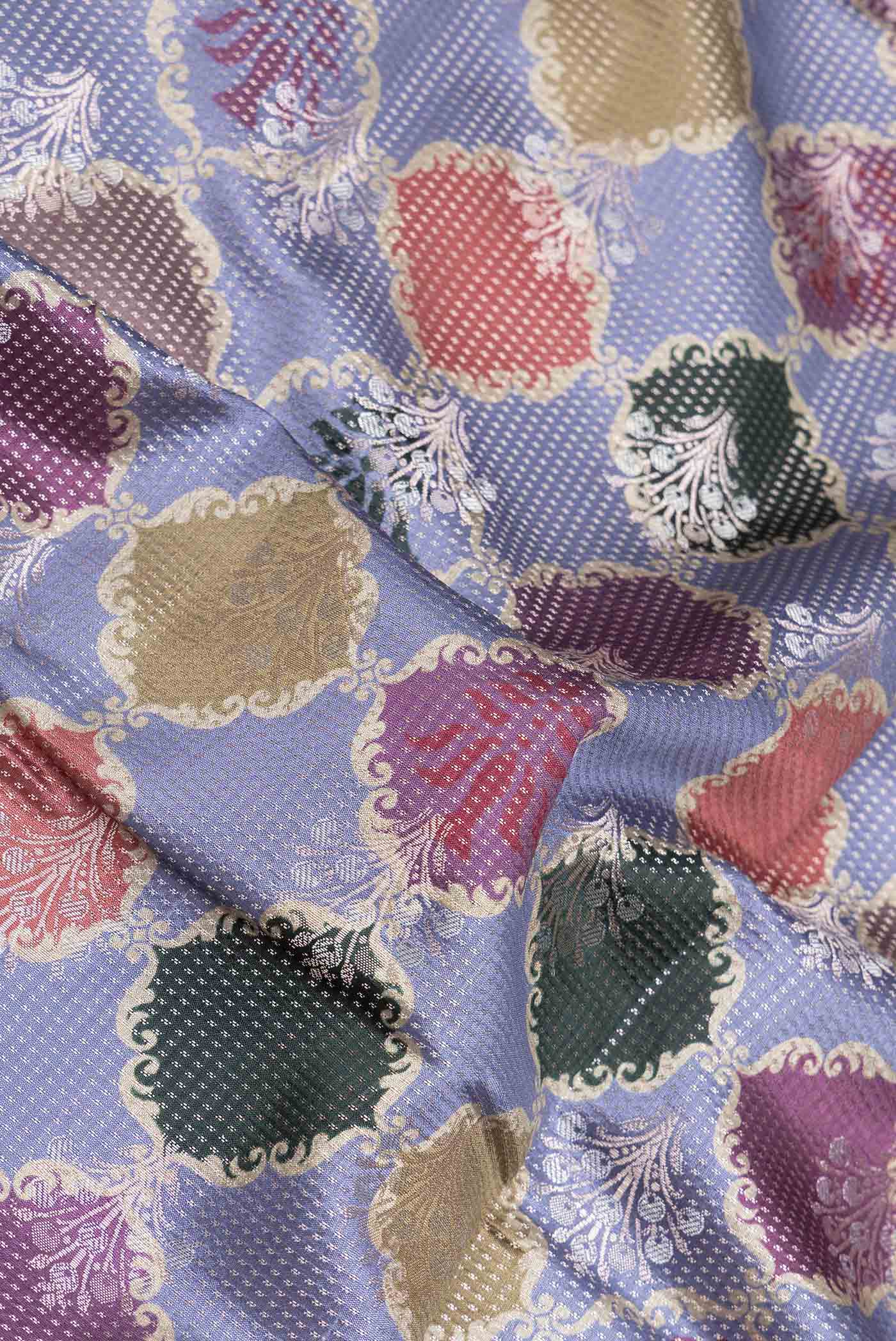 Close up of Lilac Banarasi Raw Silk Saree with Zari And Thread Butta on the body and Zari Border displaying folds