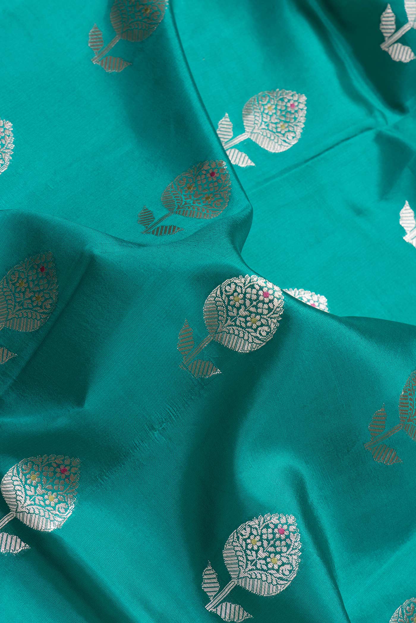 Close up of Sea Green Dual Tone Tussar Silk Saree with Zari Butta on the body and Fancy Border.  displaying folds