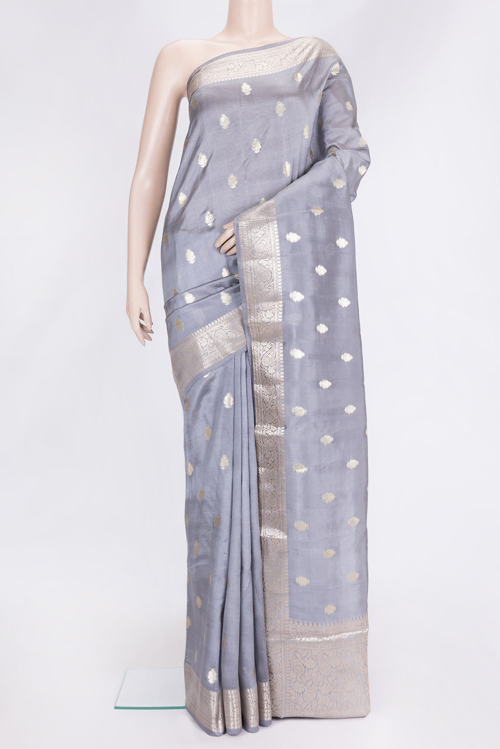 Grey Dual Tone Tussar Silk Saree with Zari Butta on the body and Zari Border.  displayed on a mannequin
