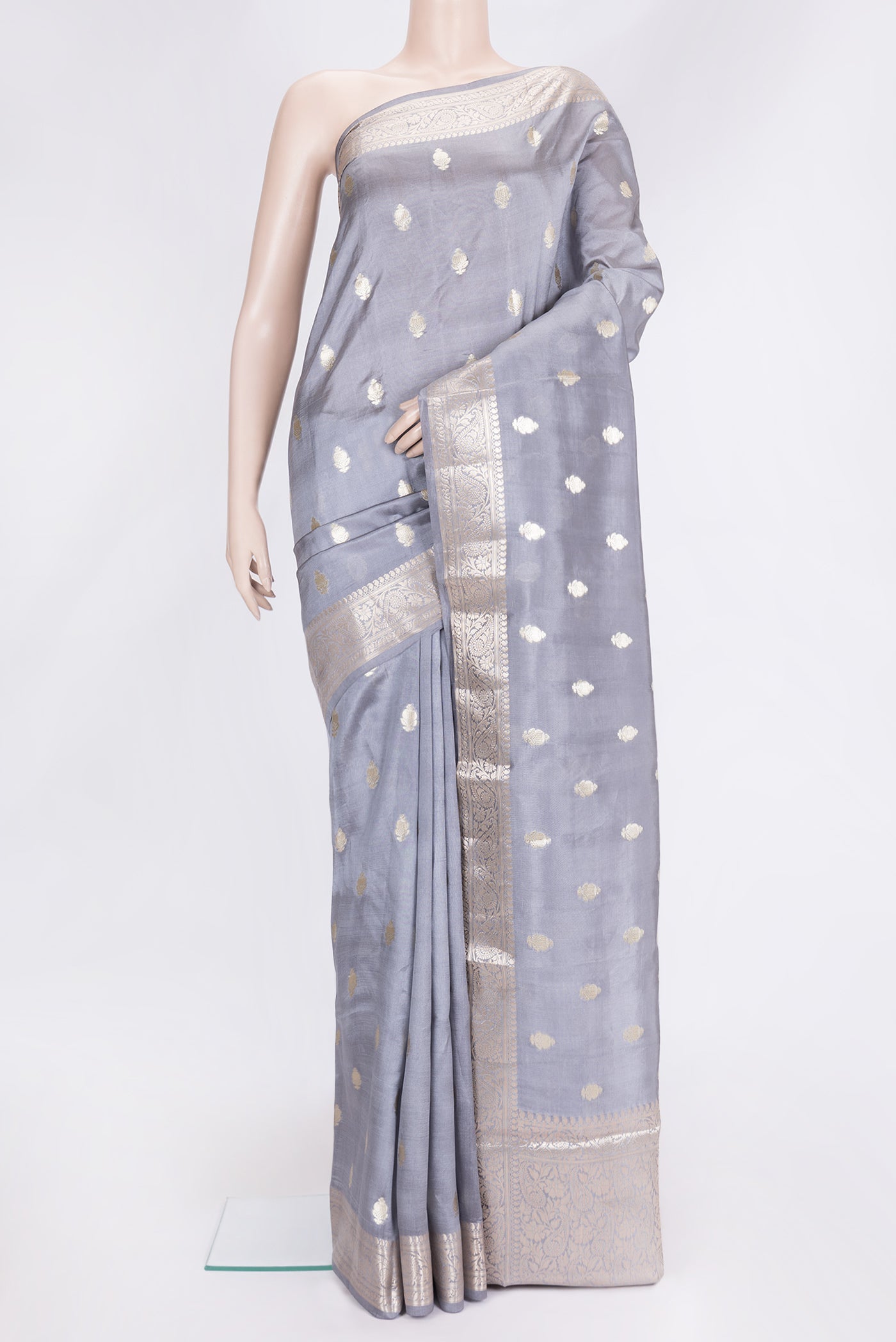 Grey Dual Tone Tussar Silk Saree with Zari Butta on the body and Zari Border.  displayed on a mannequin