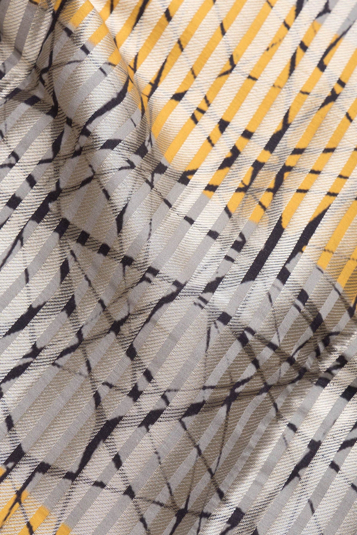 Close up of Grey and Yellow Color Tussar Silk Saree with Stripes on the body and Thin Zari Line.  displaying folds