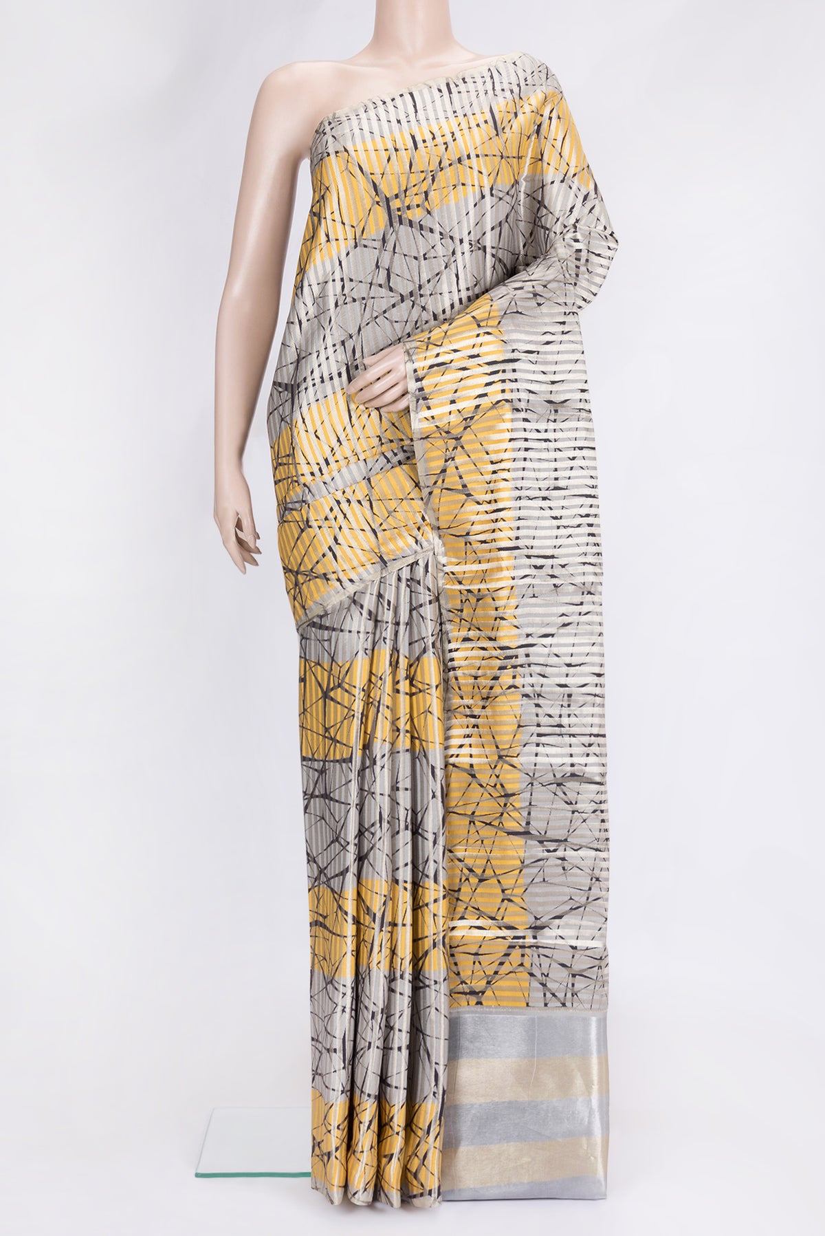 Grey and Yellow Color Tussar Silk Saree with Stripes on the body and Thin Zari Line.  displayed on a mannequin
