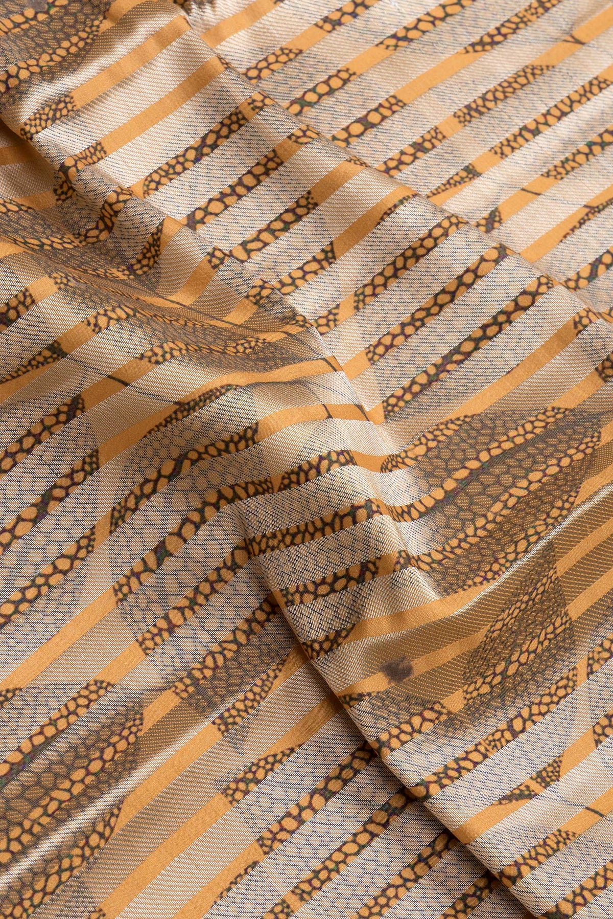 Close up of Sandal Dual Tone Tussar Silk Saree with Stripes on the body and Thin Zari Line.  displaying folds
