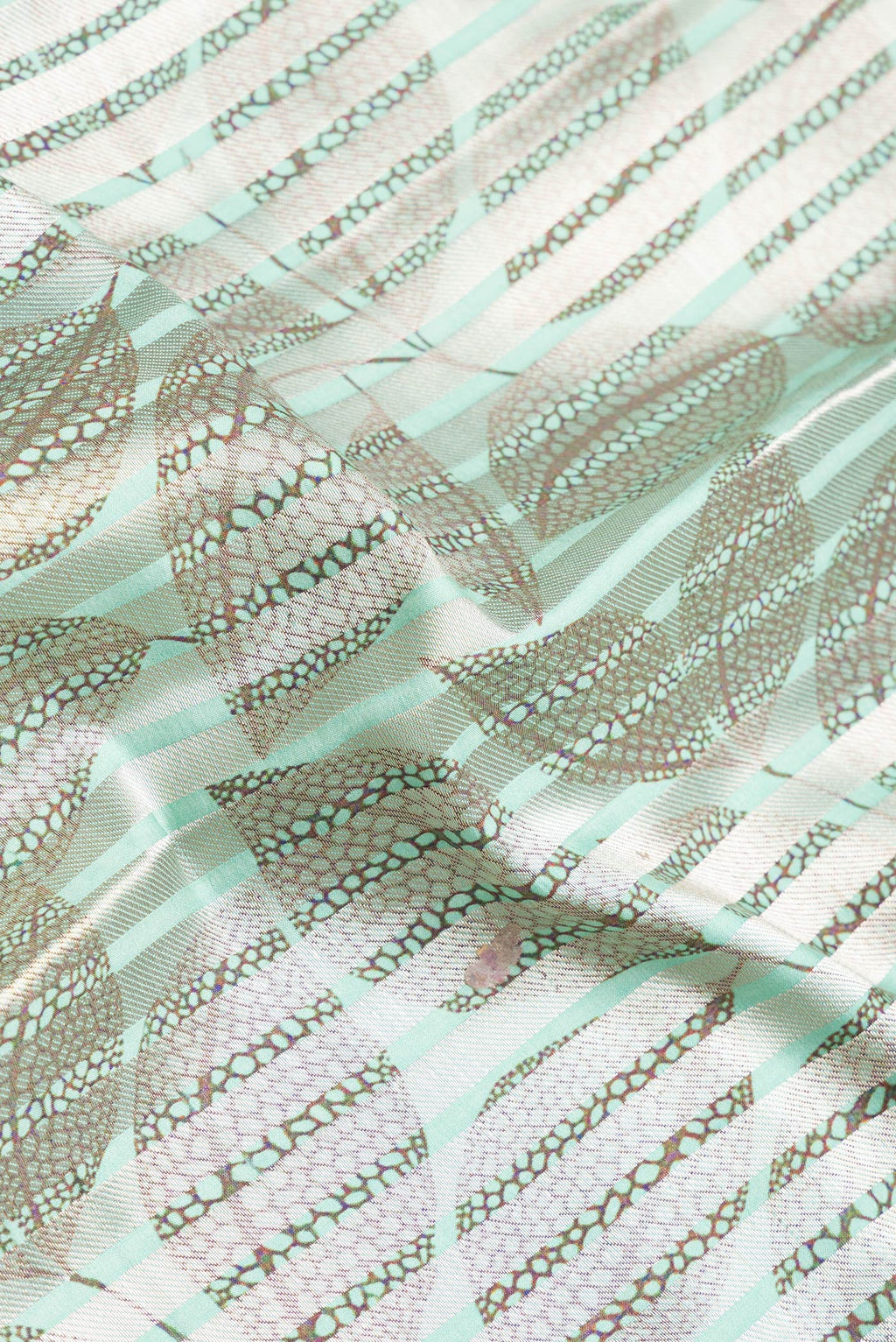 Close up of Sea Green Dual Tone Tussar Silk Saree with Stripes on the body and Without Border.  displaying folds