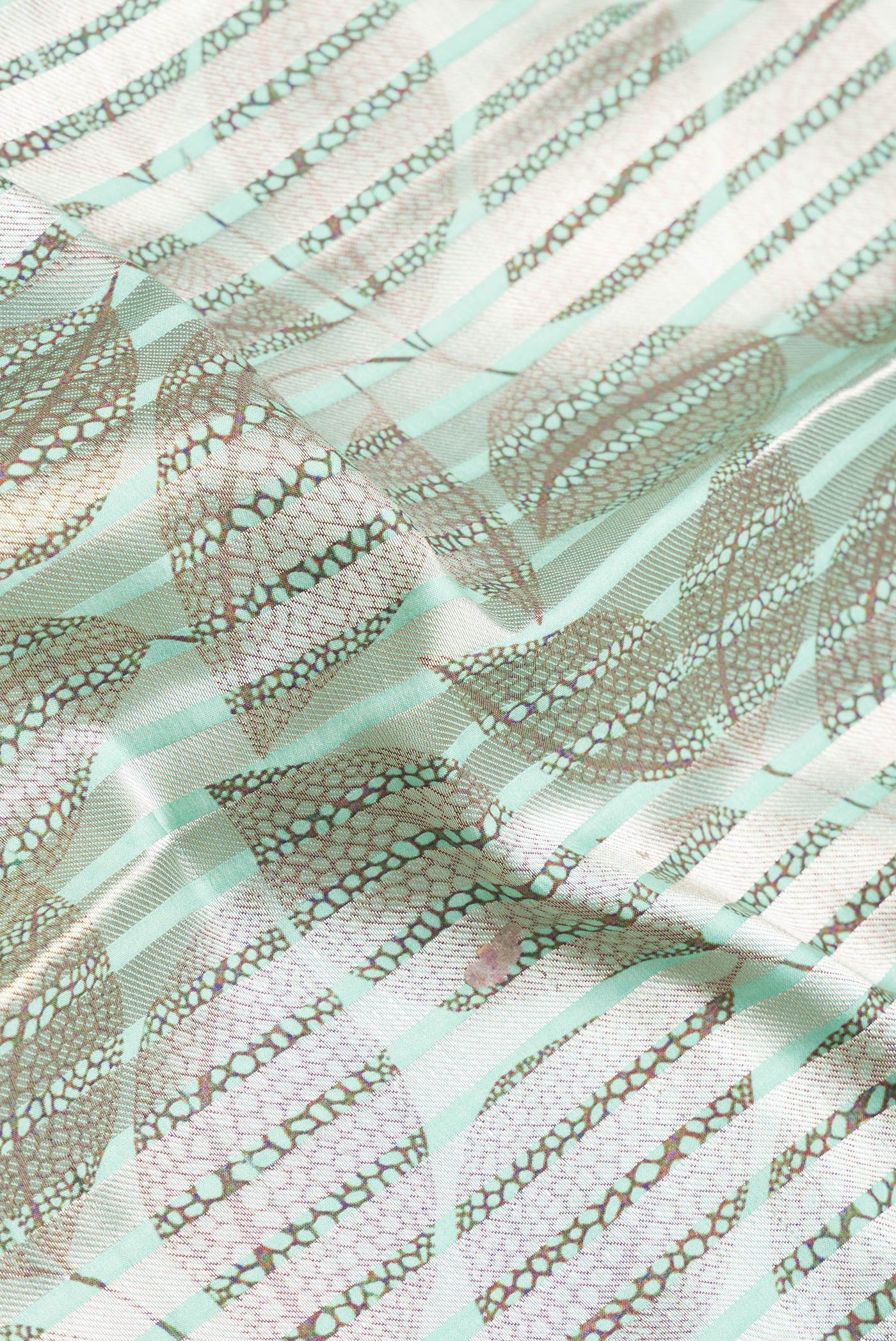 Close up of Sea Green Dual Tone Tussar Silk Saree with Stripes on the body and Without Border.  displaying folds