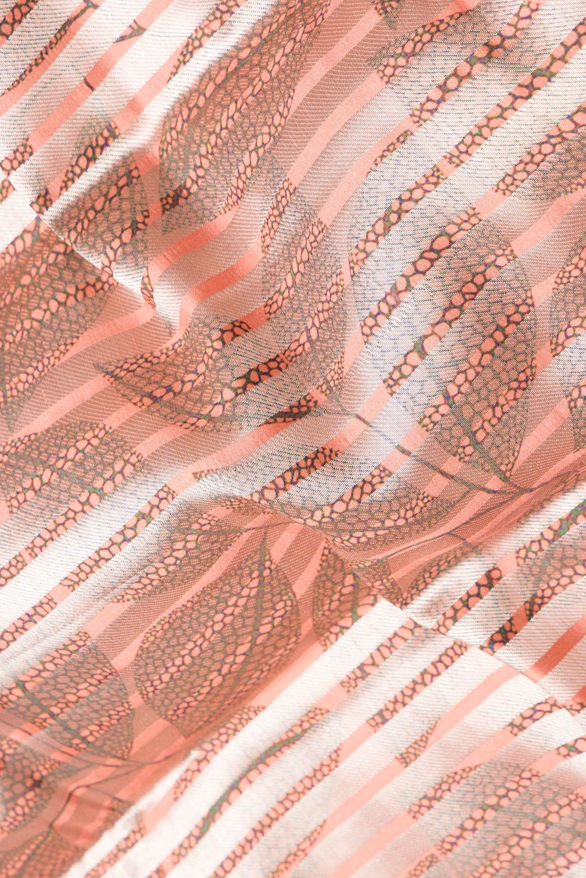 Close up of Peach Dual Tone Tussar Silk Saree with Stripes on the body and Without Border.  displaying folds