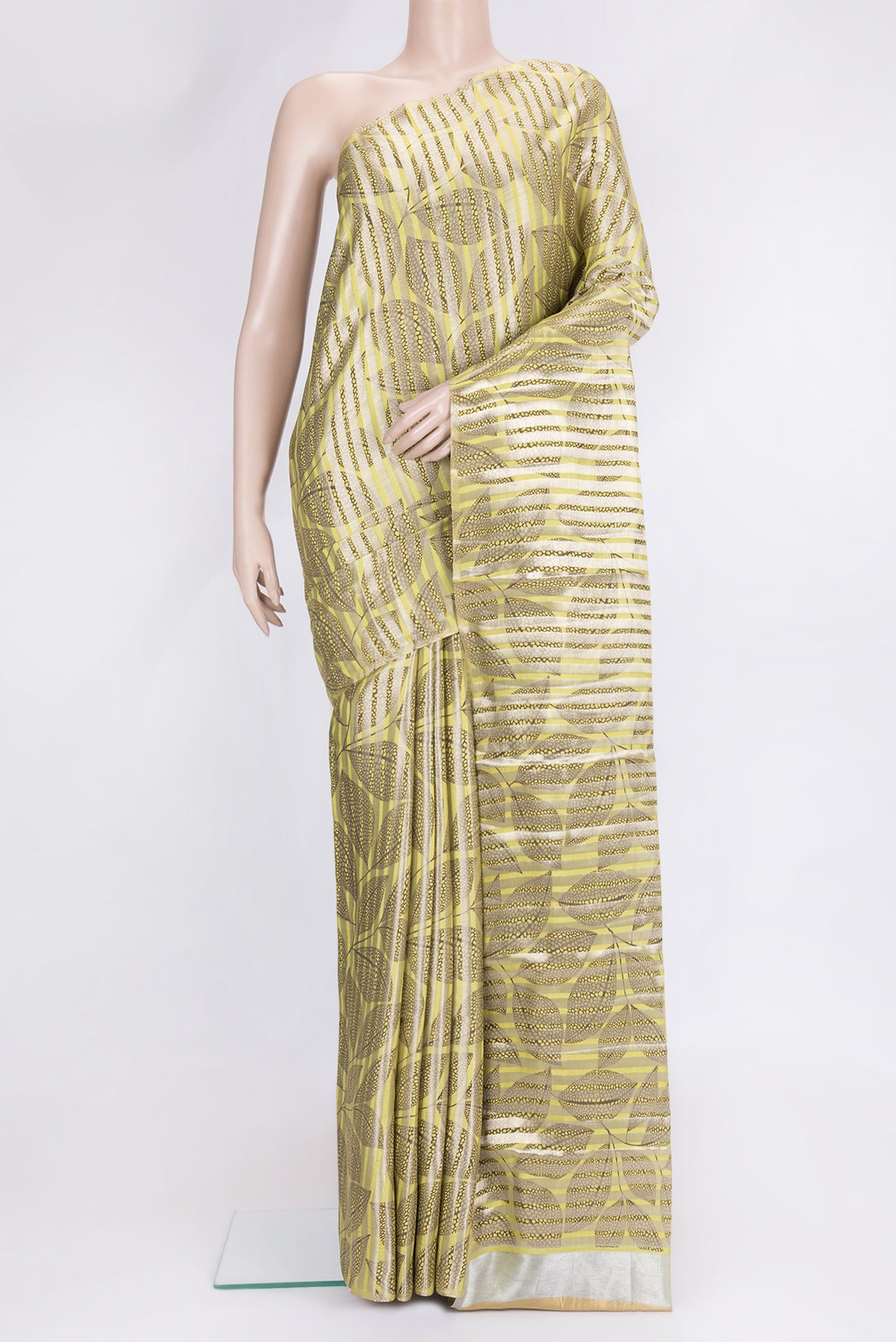 Pista Green Dual Tone Tussar Silk Saree with Stripes on the body and Thin Zari Line.  displayed on a mannequin