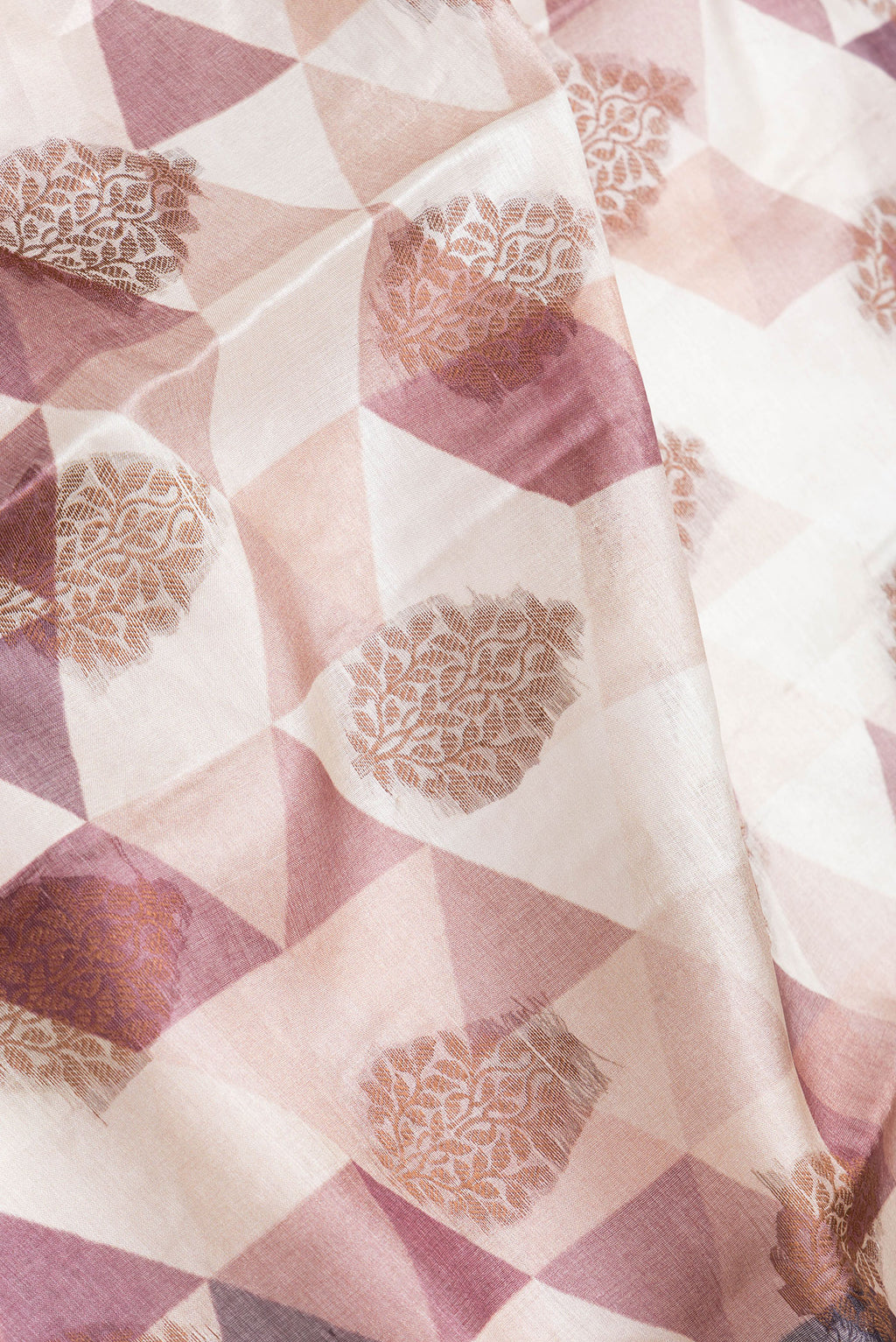 Close up of Brown Dual Tone Tussar Silk Saree with Printed design on the body and Zari Border.  displaying folds