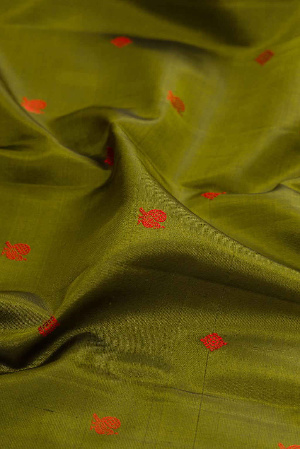Close up of Mehandi Green Kanjivaram Silk Saree with Thread Butta on the body and Thread Border.  displaying folds