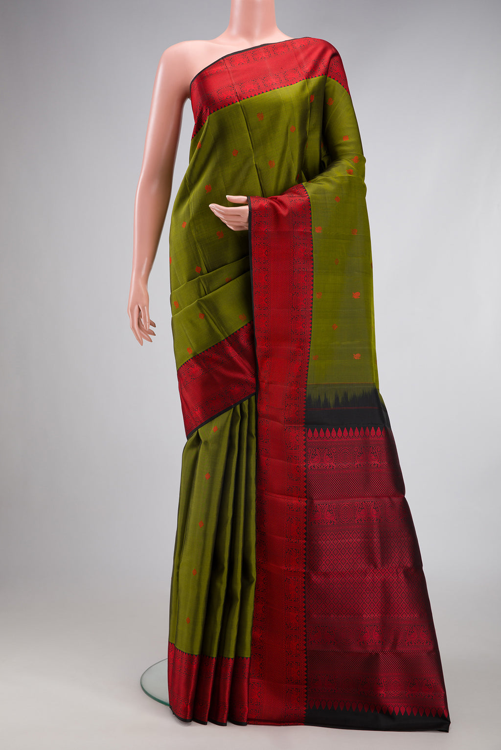 Mehandi Green Kanjivaram Silk Saree with Thread Butta on the body and Thread Border.  displayed on a mannequin