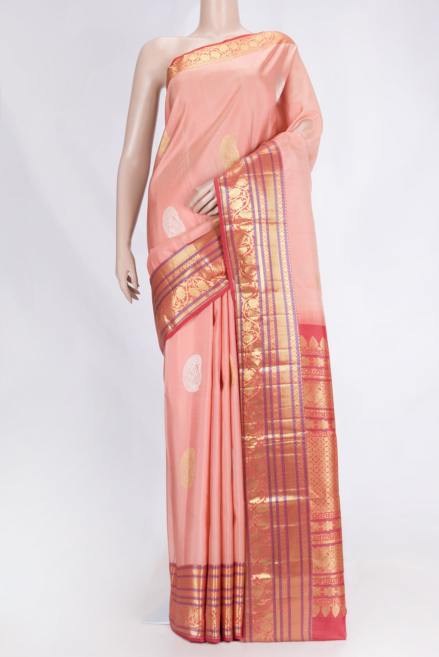 Golden Peach Dual Tone Kanjivaram Saree with Zari Butta on the body and Zari Border.  displayed on a mannequin