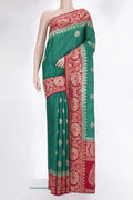 Green Tussar Saree with Zari Butta on the body and Fancy Border.  displayed on a mannequin