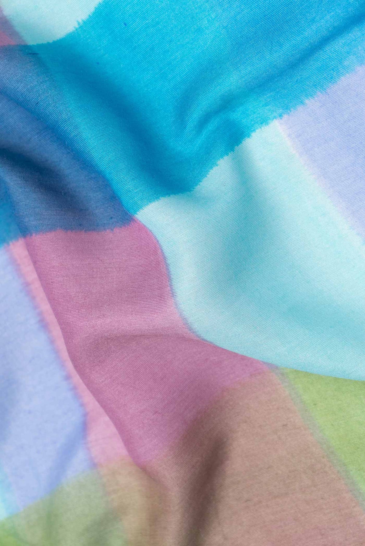 Close up of Sky Blue, Pink and Green Color Tussar Silk Saree with Printed design on the body and Zari Border displaying folds