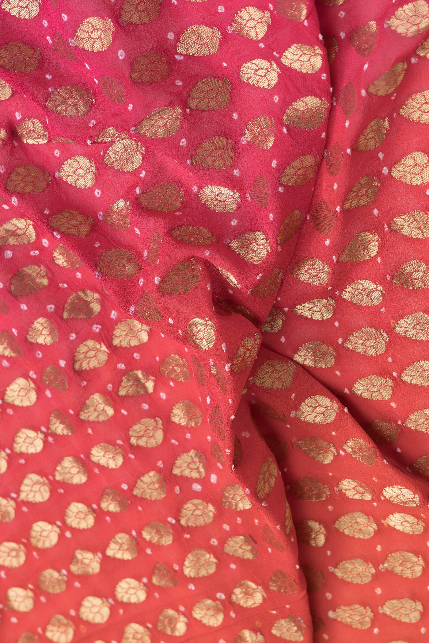 Close up of Orange Dual Tone Mysore Georgette Saree with Zari Brocade on the body and Without Border.  displaying folds