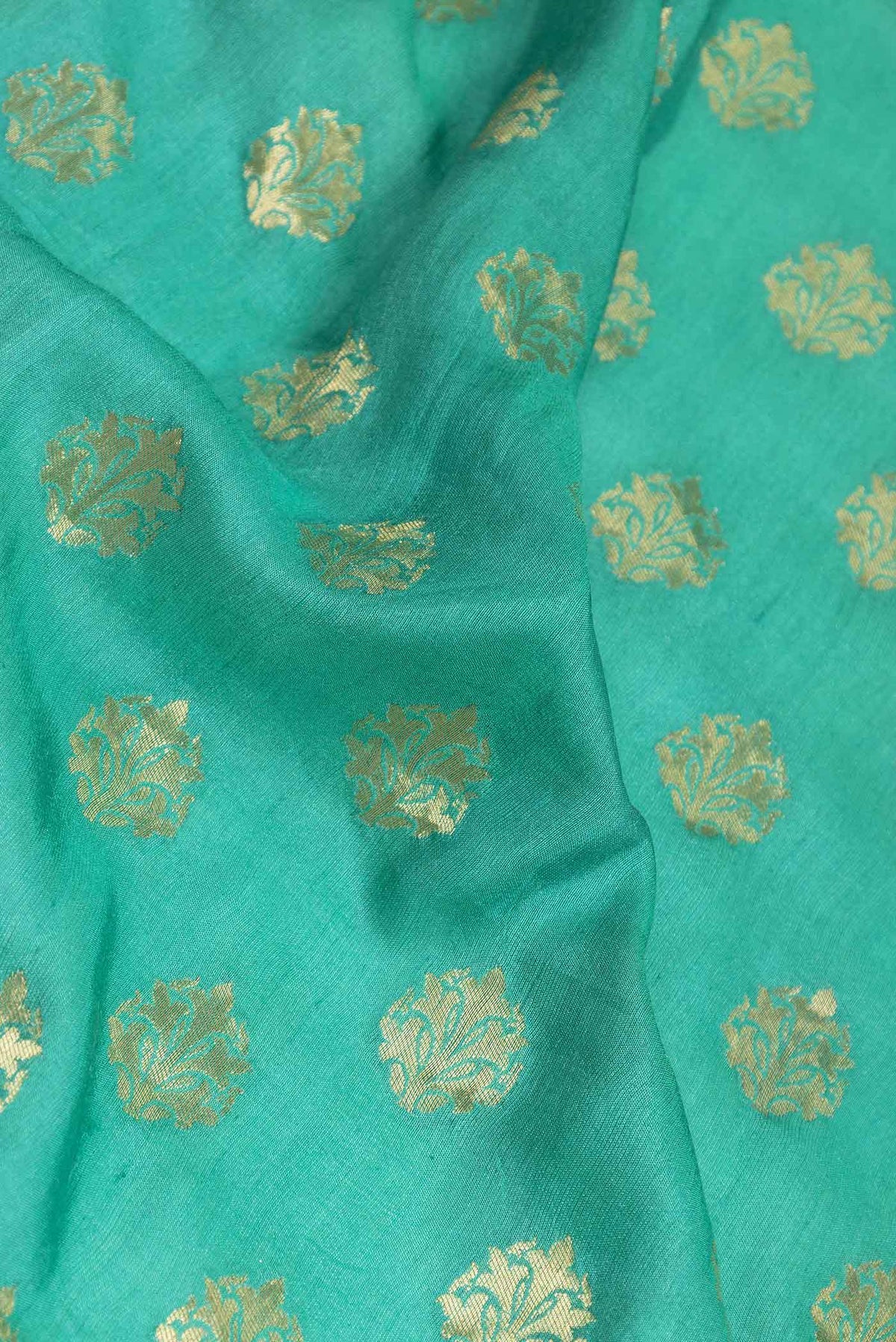 Close up of Green Dual Tone Banarasi Silk Saree with Zari Brocade on the body and Zari Border displaying folds