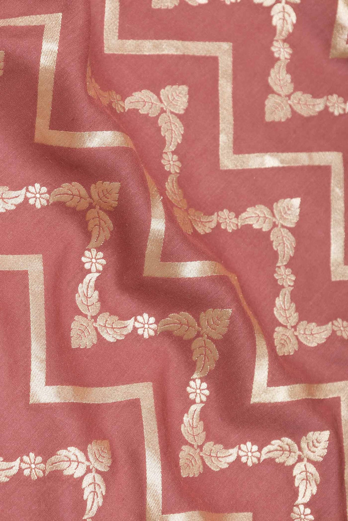 Close up of Mauve Dual Tone Tussar Silk Saree with Zari And Thread Butta on the body and Zari Border displaying folds
