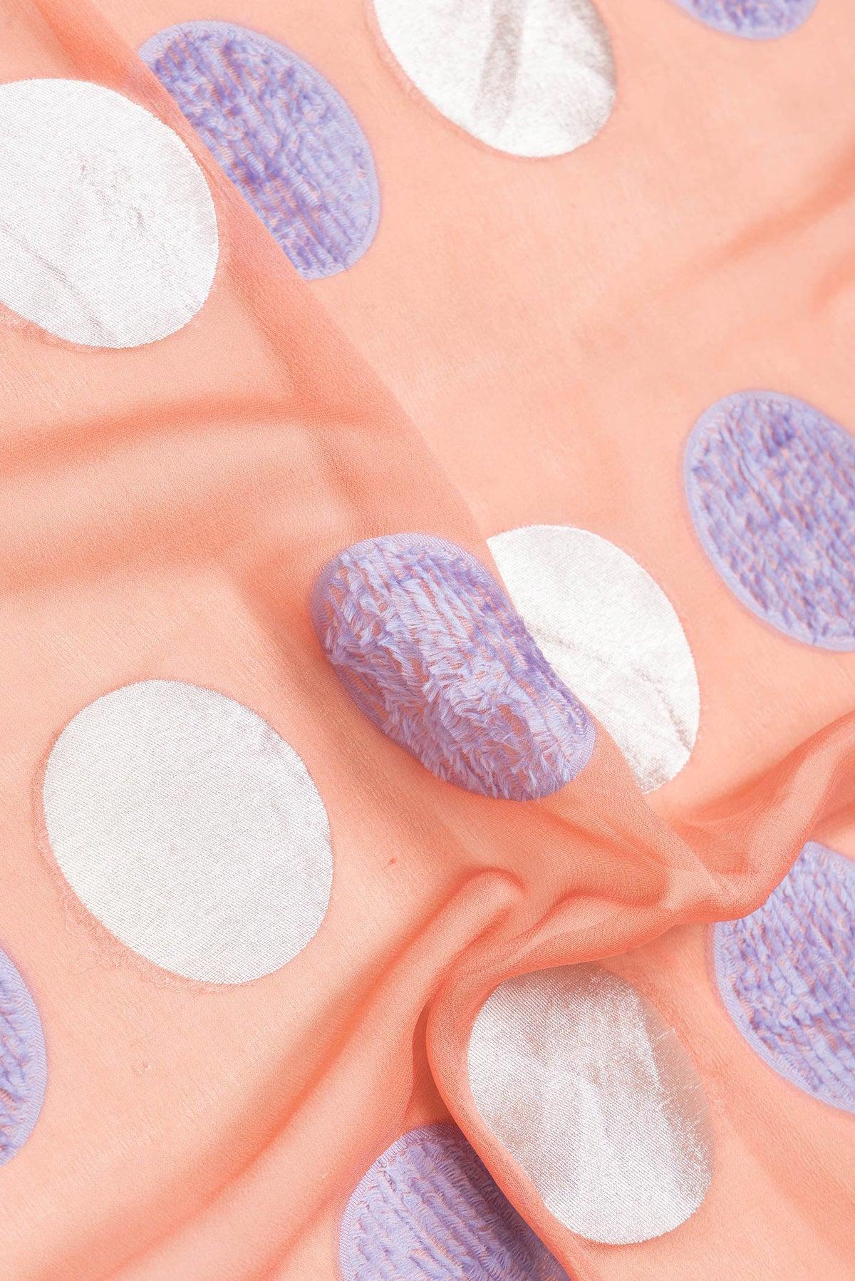 Close up of Peach Dual Tone Banarasi Georgette Saree with Zari And Thread Butta on the body and Zari Border.  displaying folds