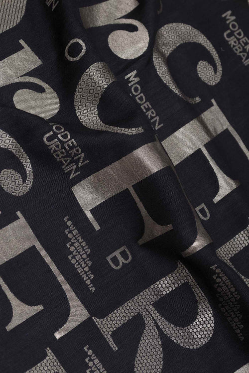 Close up of Black Dual Tone Banarasi Silk Saree with Zari Brocade on the body and Zari Border displaying folds