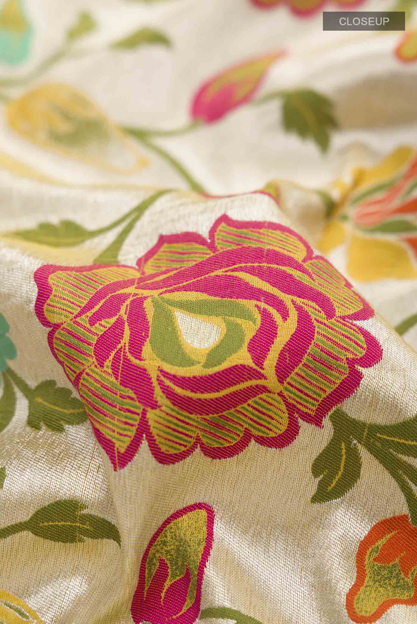 Close up of Yellow Banarasi Georgette Saree with Zari And Thread Butta on the body and Zari Border displaying folds