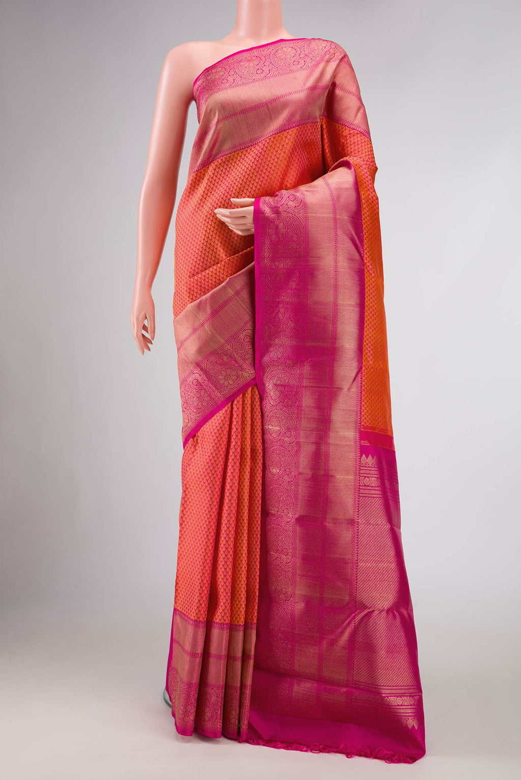 Pure Silk Pure Zari Peach Dual Tone Kanjivaram Saree with Jacquard design on the body and Zari Border.  displayed on a mannequin
