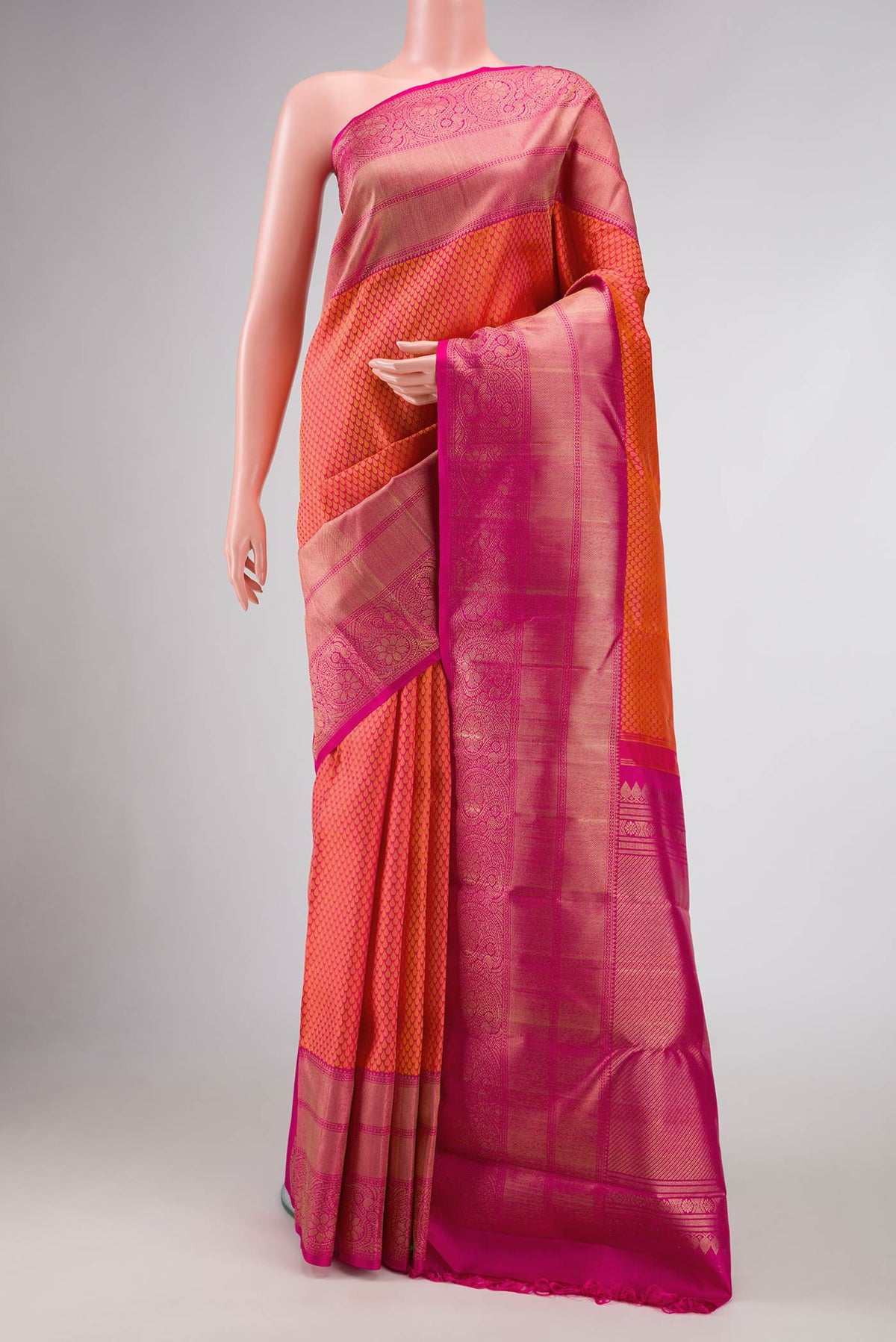 Pure Silk Pure Zari Peach Dual Tone Kanjivaram Saree with Jacquard design on the body and Zari Border.  displayed on a mannequin