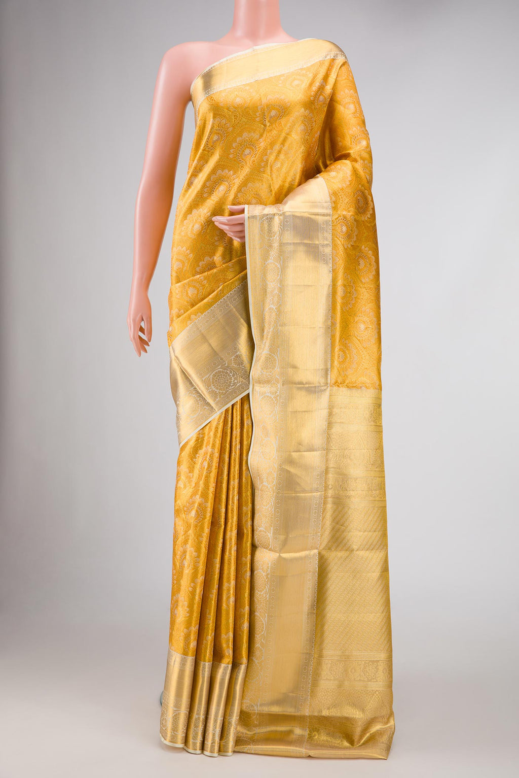 Gold Dual Tone Kanjivaram Tissue Silk Saree with Zari Brocade on the body and Zari Border.  displayed on a mannequin