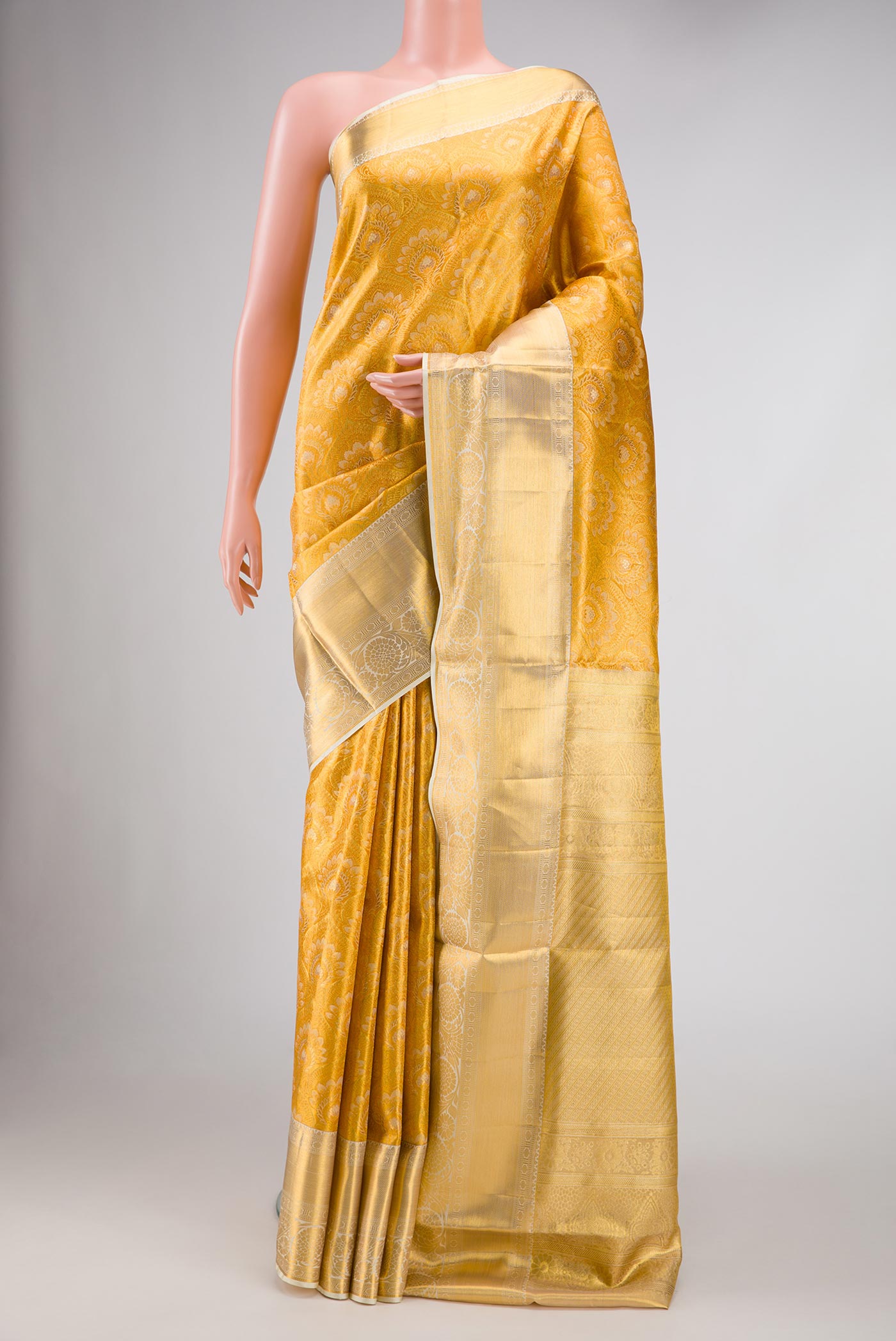 Gold Dual Tone Kanjivaram Tissue Silk Saree with Zari Brocade on the body and Zari Border.  displayed on a mannequin