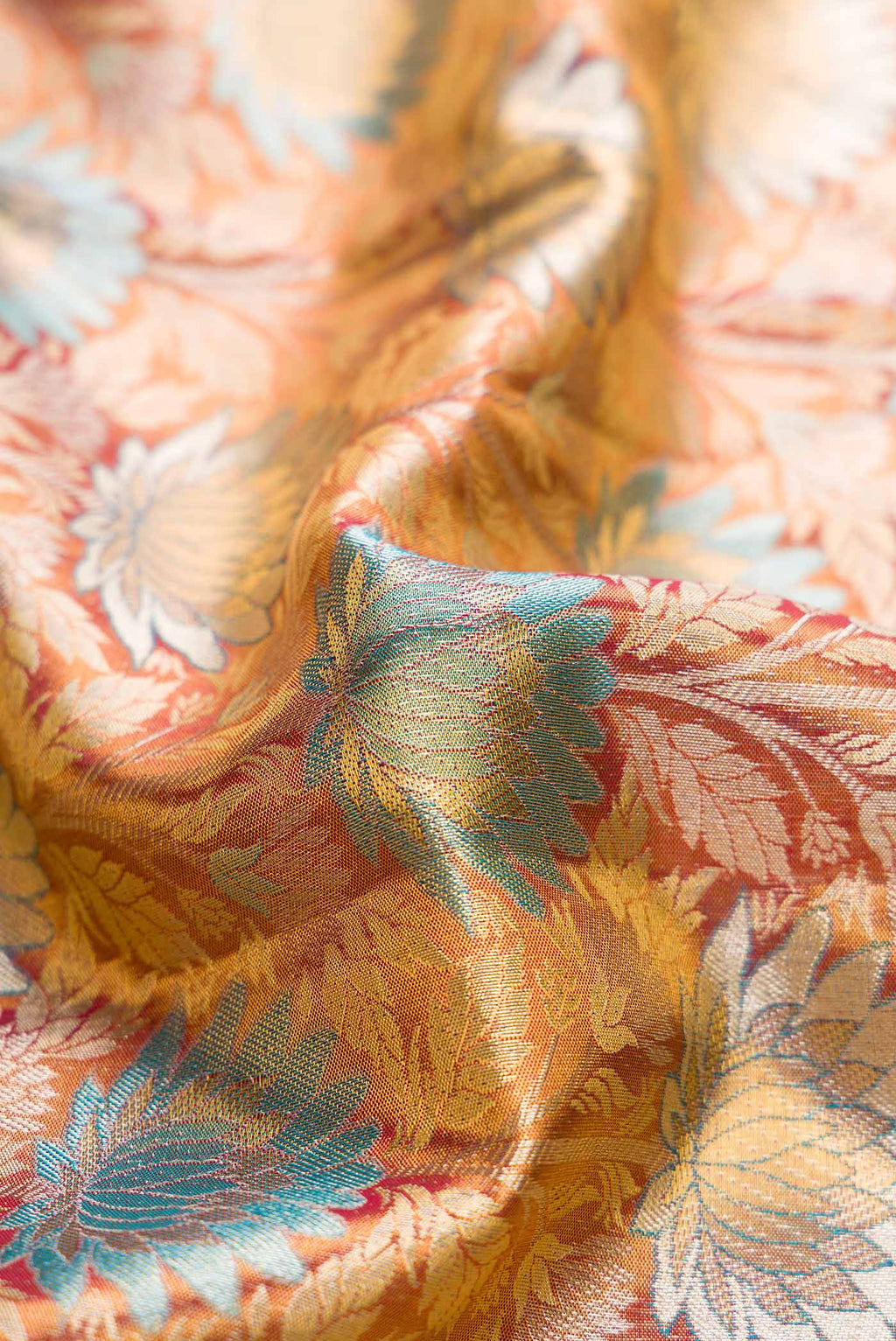 Close up of Maroon Dual Tone Kanjivaram Tissue Silk Saree with Zari Brocade on the body and Zari Border.  displaying folds