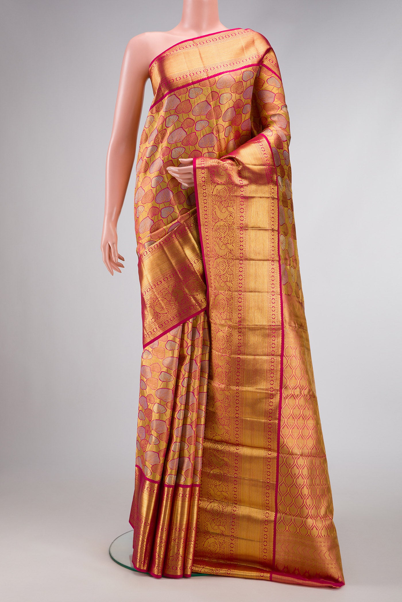 Gold Dual Tone Kanchipuram Tissue Silk Saree with Zari Brocade on the body and Zari Border.  displayed on a mannequin