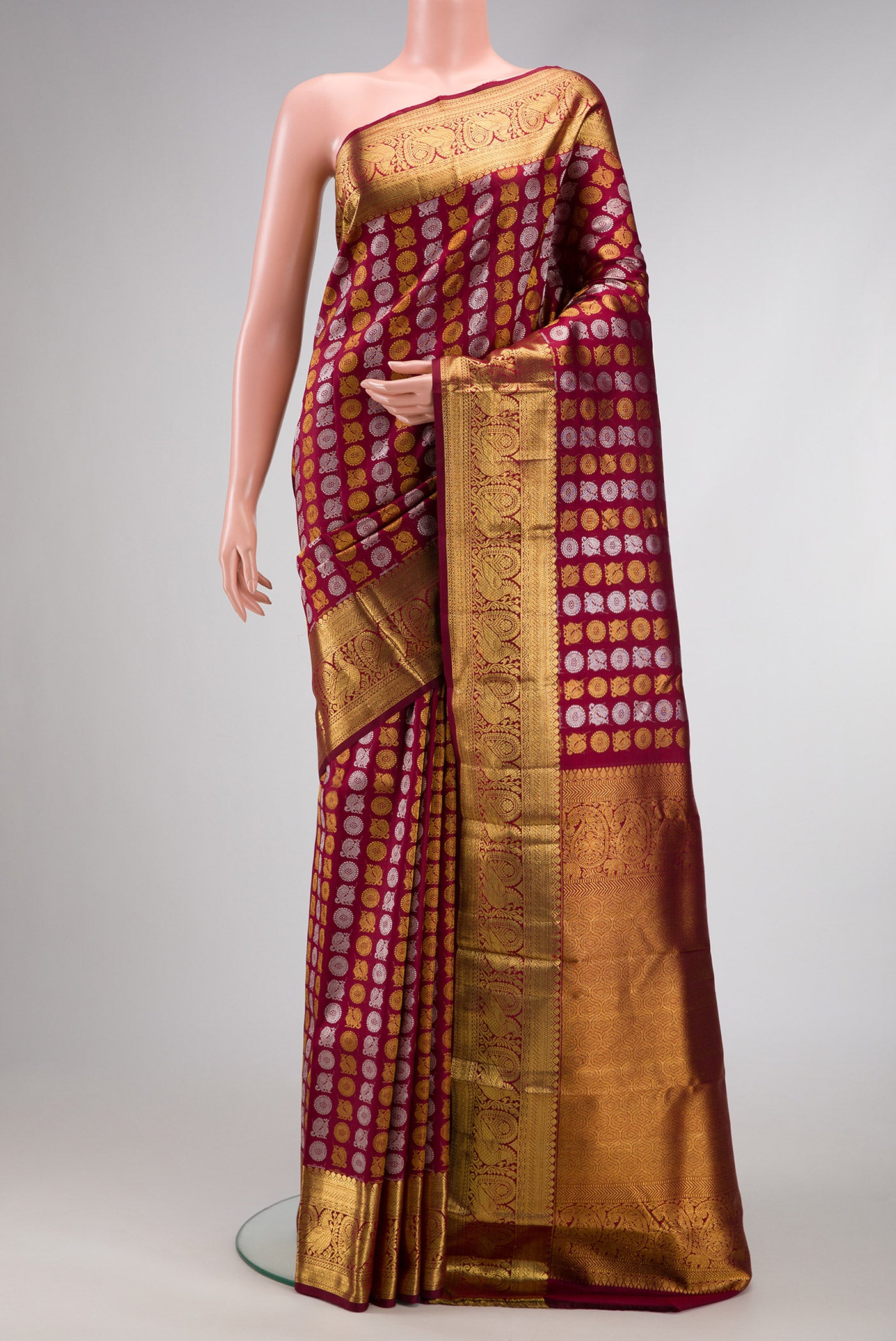 Maroon Dual Tone Kanchipuram Silk Saree with Zari Brocade on the body and Zari Border.  displayed on a mannequin