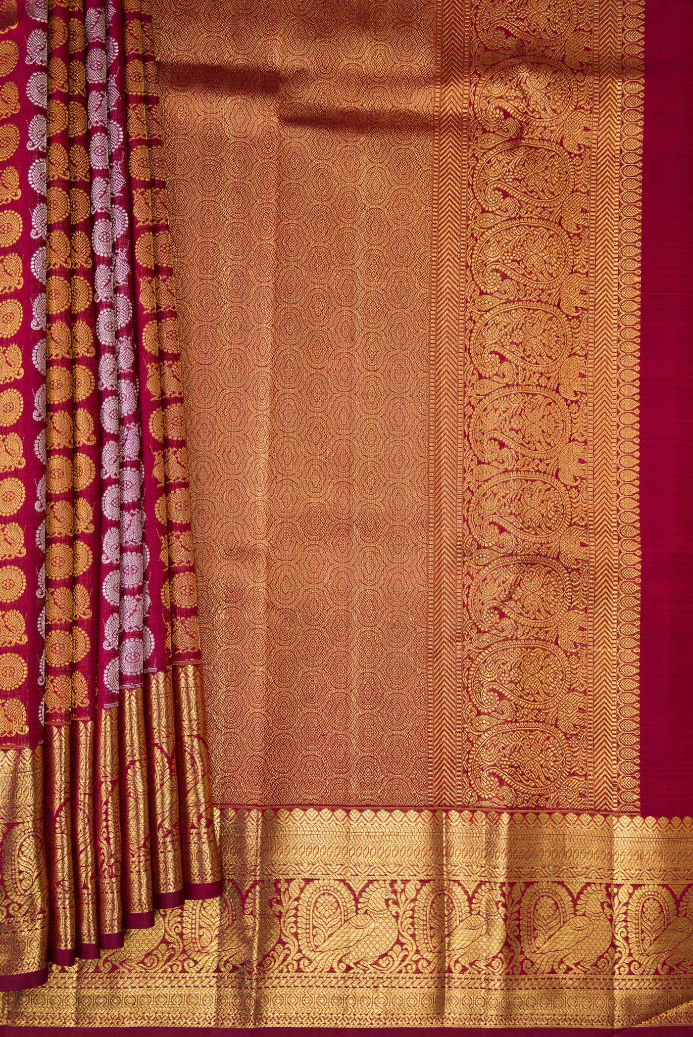 Pleats and pallu of Maroon Dual Tone Kanchipuram Silk Saree with Zari Brocade on the body and Zari Border. 